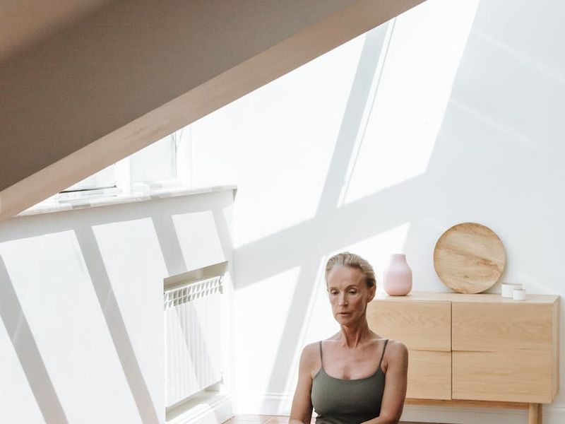 Person practicing yoga flow in a bright minimalist room